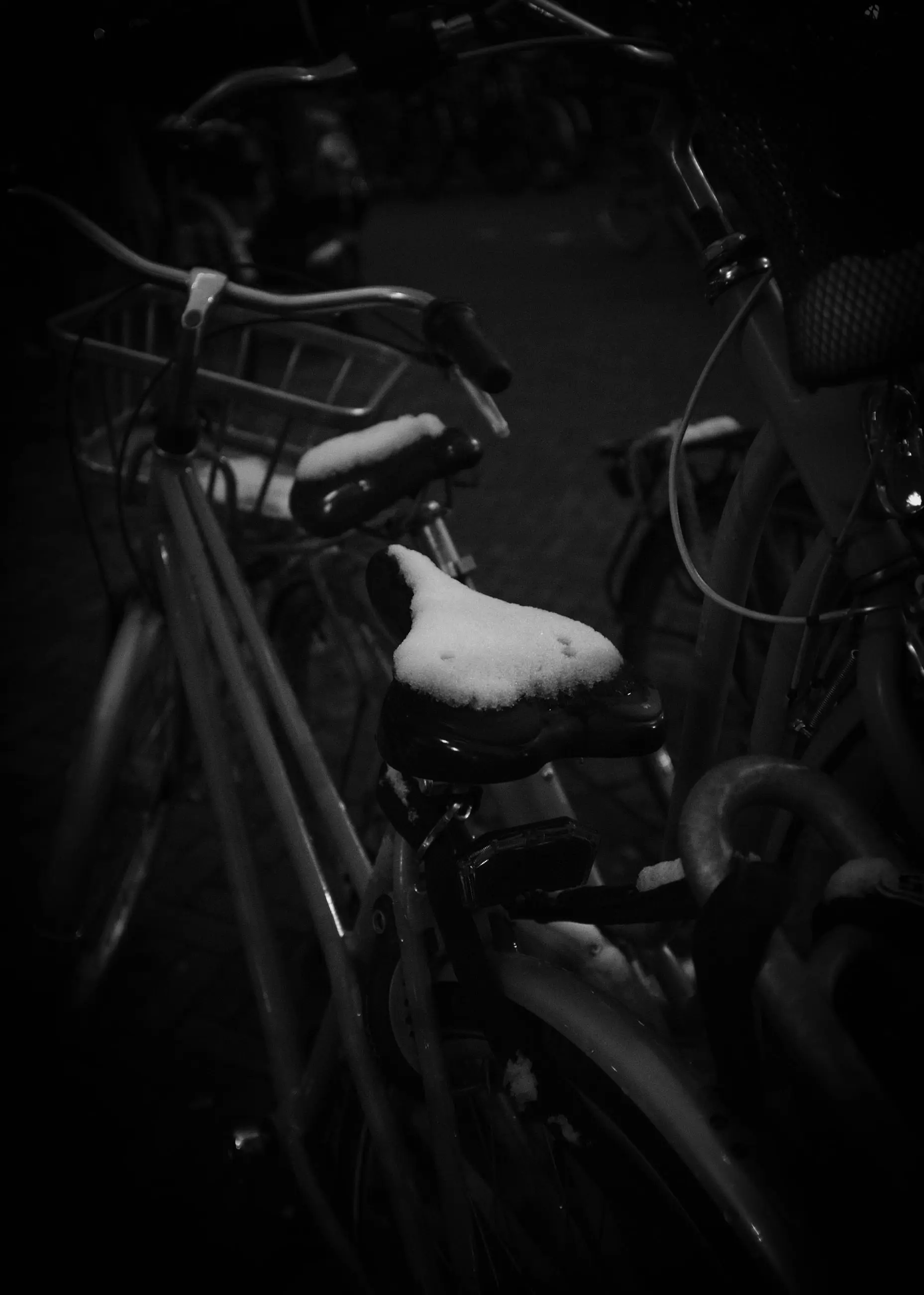 A bicycle seat and frame in the dark