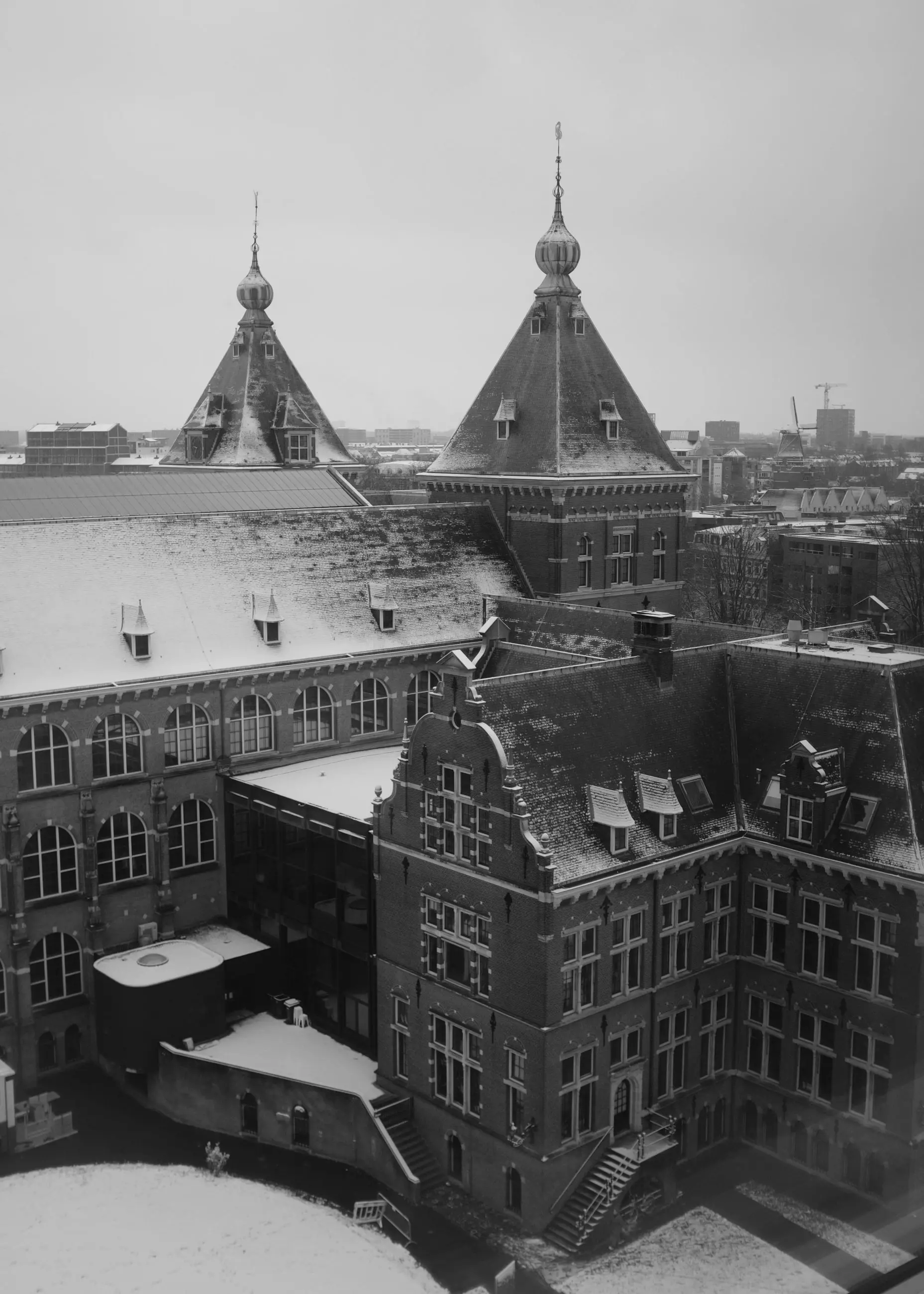 Snow-covered towers and roofs seen from above